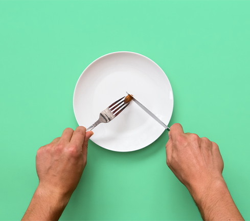 person eating just one almond on a plate, featured image around intermittent fasting and multiple sclerosis