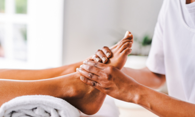 Massaging a foot - featured image for reflexology and ms