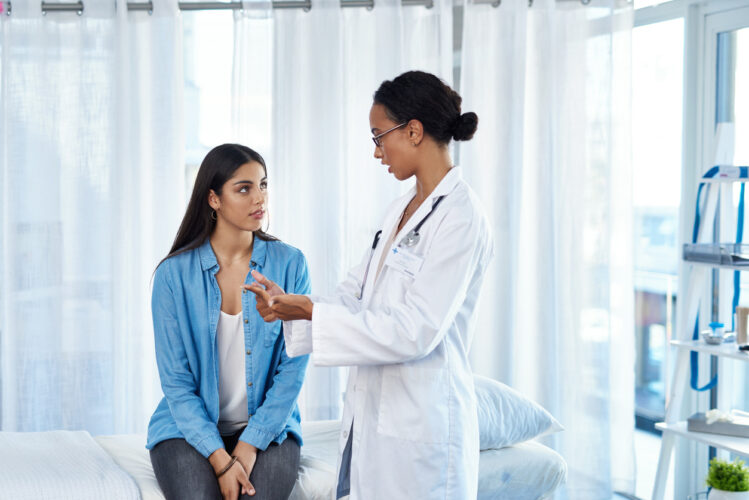 Young woman speaking to a doctor - illustrates a new hormone therapy on the horizon for women with MS