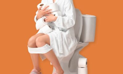 Person sitting on the toilet suffering with constipation from multiple sclerosis
