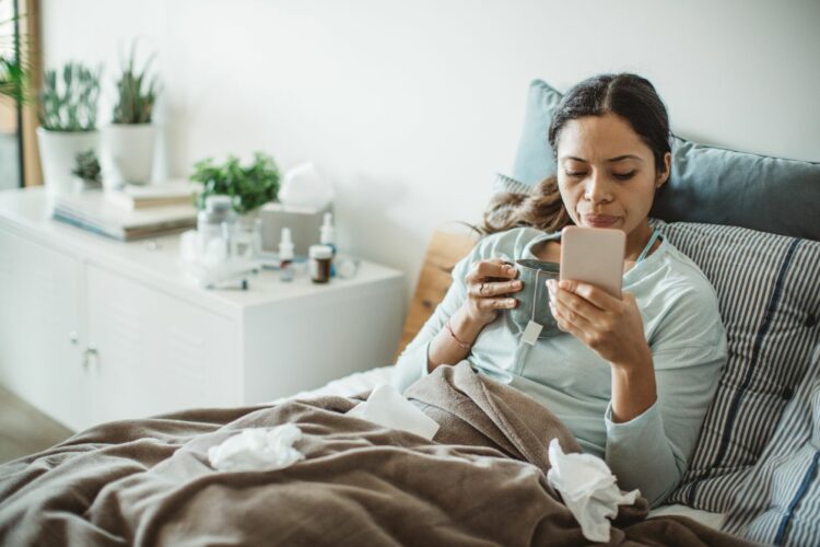 Woman resting in bed with a common cold and multiple sclerosis
