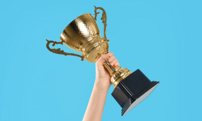 Featured image of a person holding up a trophy for the friends of MS-UK Awards 2023