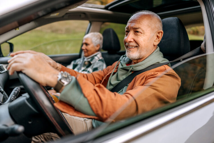 Older couple driving, illustrating the blog topic of car insurance when you have MS