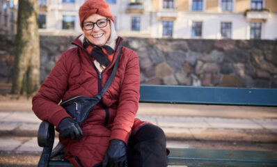 Featured image of a woman on a bench illustrating how SPMS risk is declining