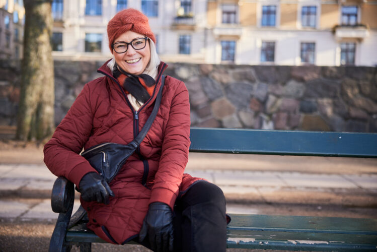 Featured image of a woman on a bench illustrating how SPMS risk is declining