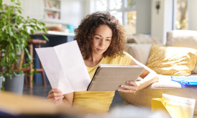 Woman looking at her finances, featured image for blog around reapplying for PIP