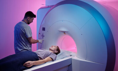 Woman going through an MRI machine, featured image for a blog with the topic around MRI developments