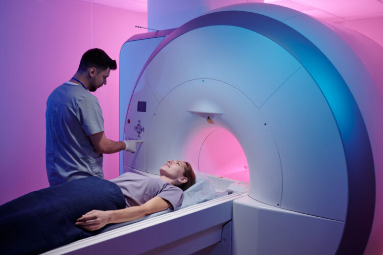 Woman going through an MRI machine, featured image for a blog with the topic around MRI developments