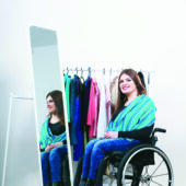 Woman in a wheelchair looking at clothes