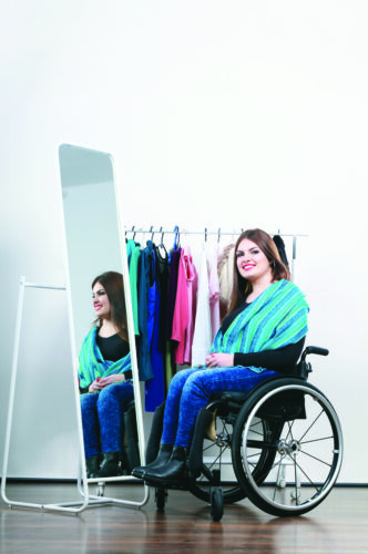 Woman in a wheelchair looking at clothes