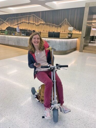 Image is of Shelia on her mobility device
