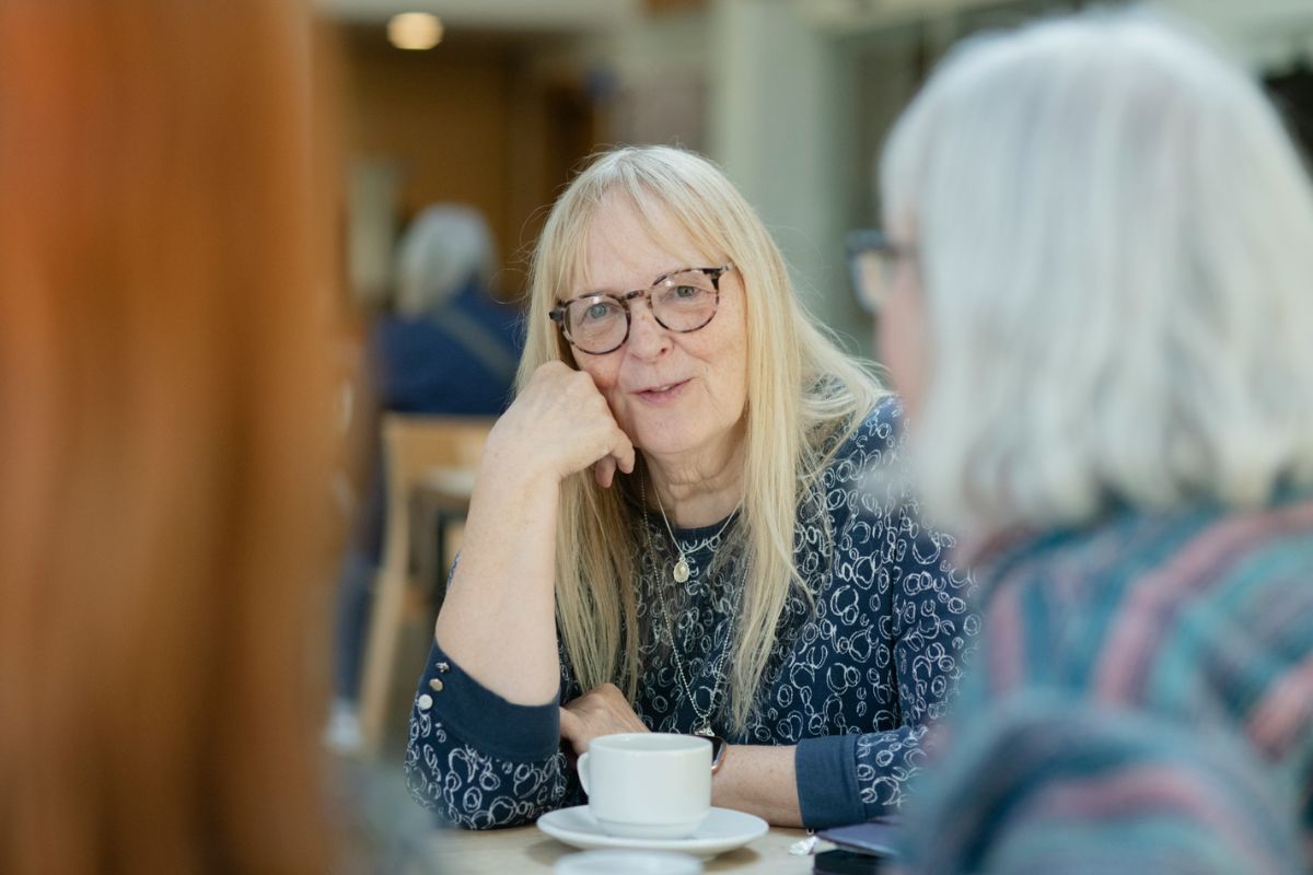 Older women talking to each other about MS in a cafe