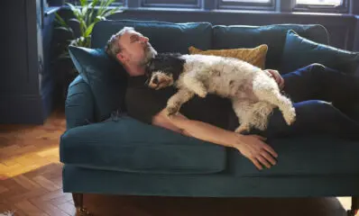 Man sleeping soundly with dog on lap
